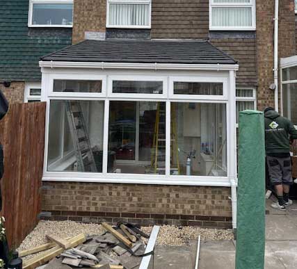 Fully installed tiled conservatory roof with white uPVC frame in Newcastle garden