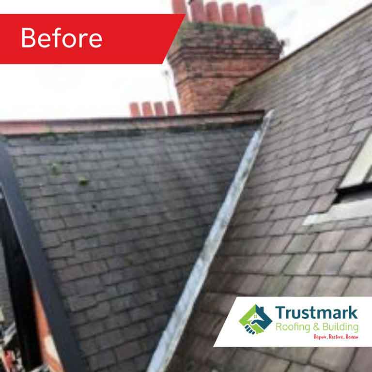 Before photo showing a chimney in Northumberland with moss on tiles, deteriorated flashing, and signs of moisture penetration near the roofline.