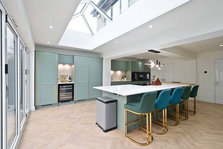 Open plan living space inside a Guardian home extension with kitchen island and natural light