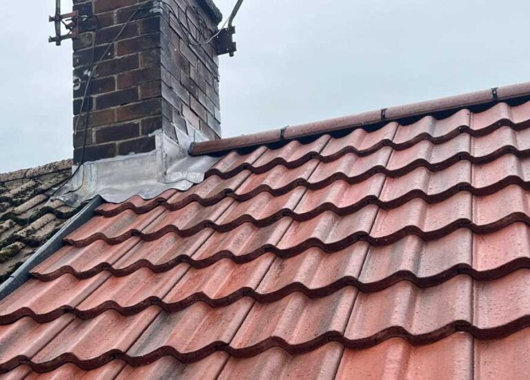 Roof tile replacement work on a pitched tiled roof in Gateshead after storm damage.