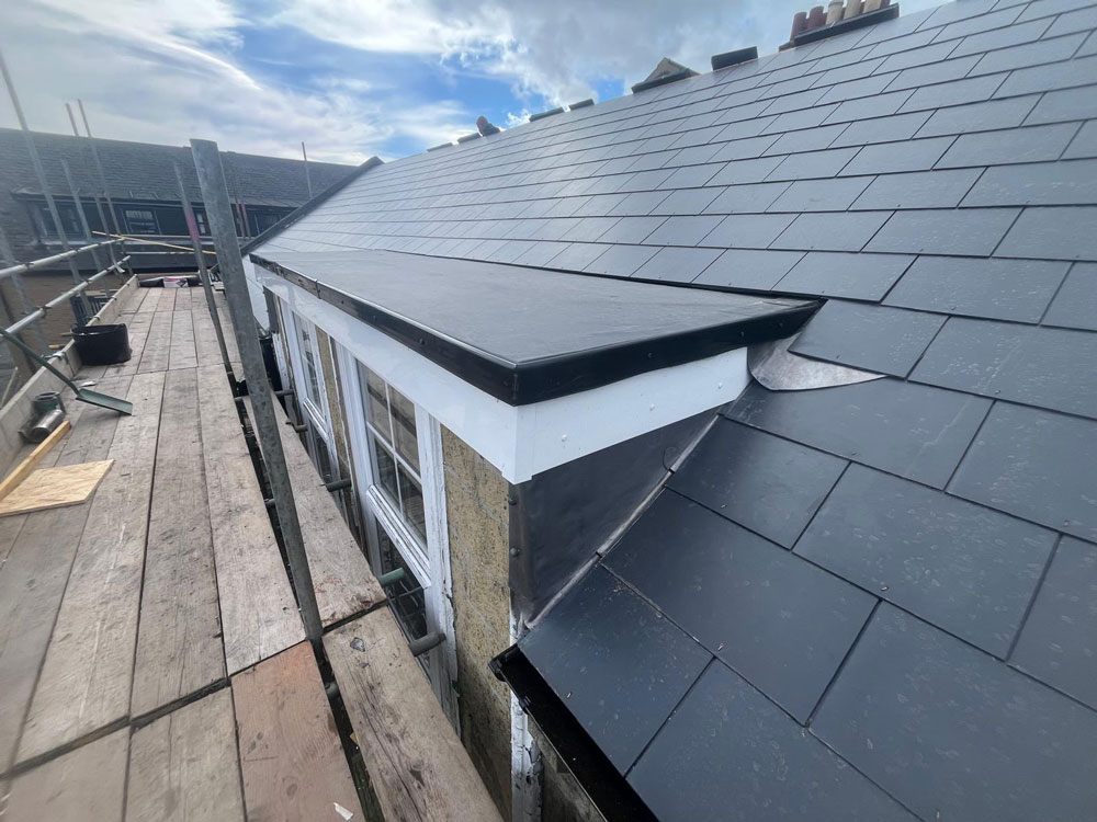 New slate pitched roof with leadwork and flat dormer roof completed by Trustmark Roofing & Building in Newcastle.