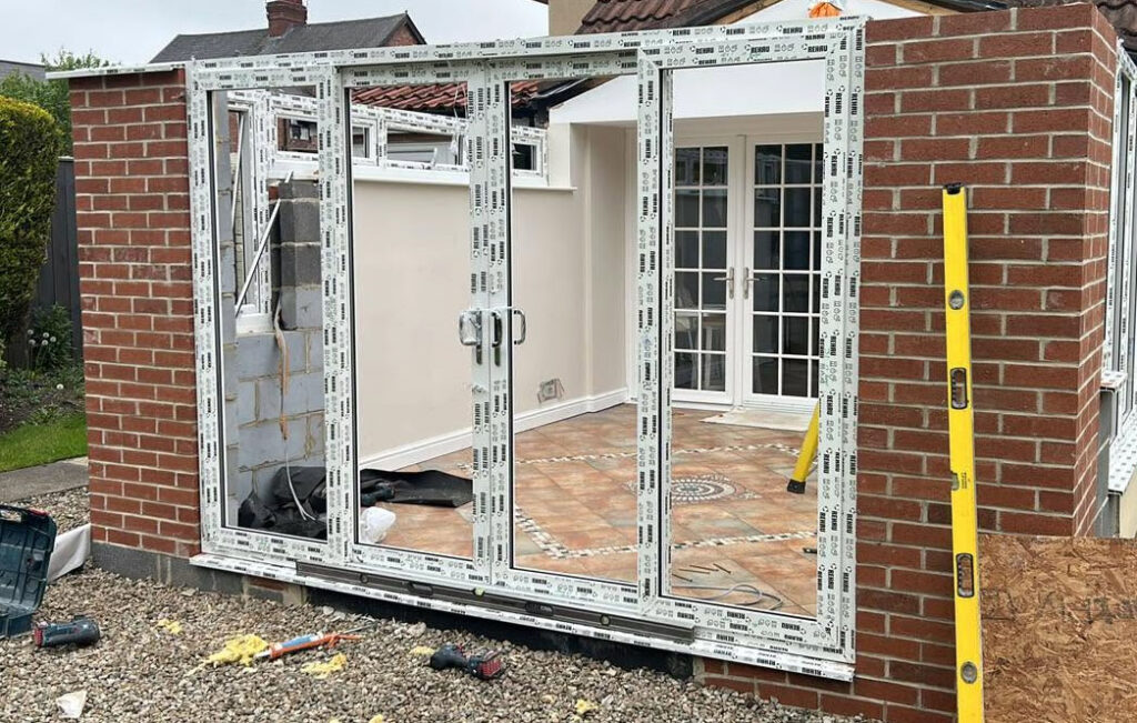 an installation of french doors and side windows